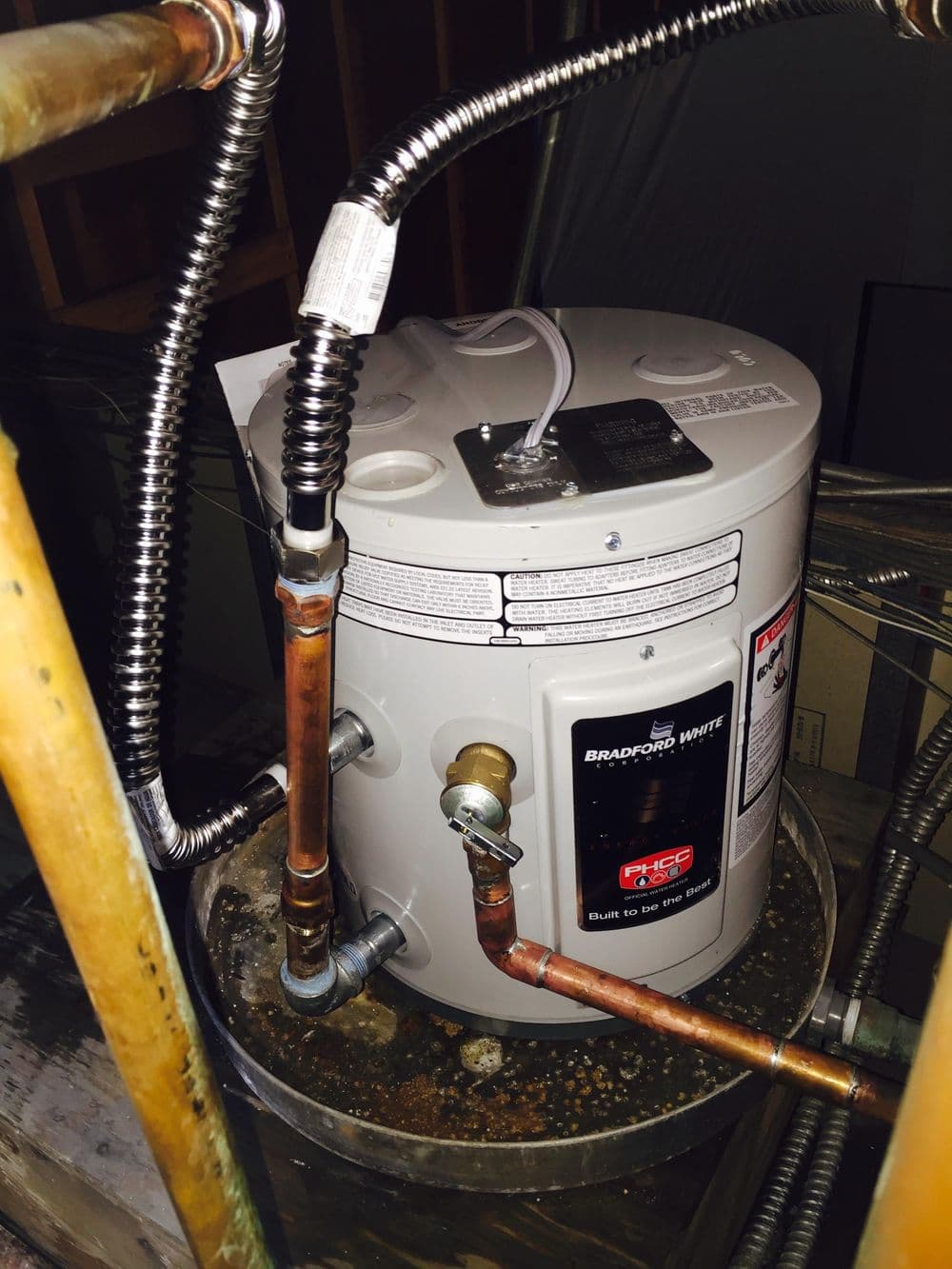 Bradford White water heater with copper piping in a home installation setting.