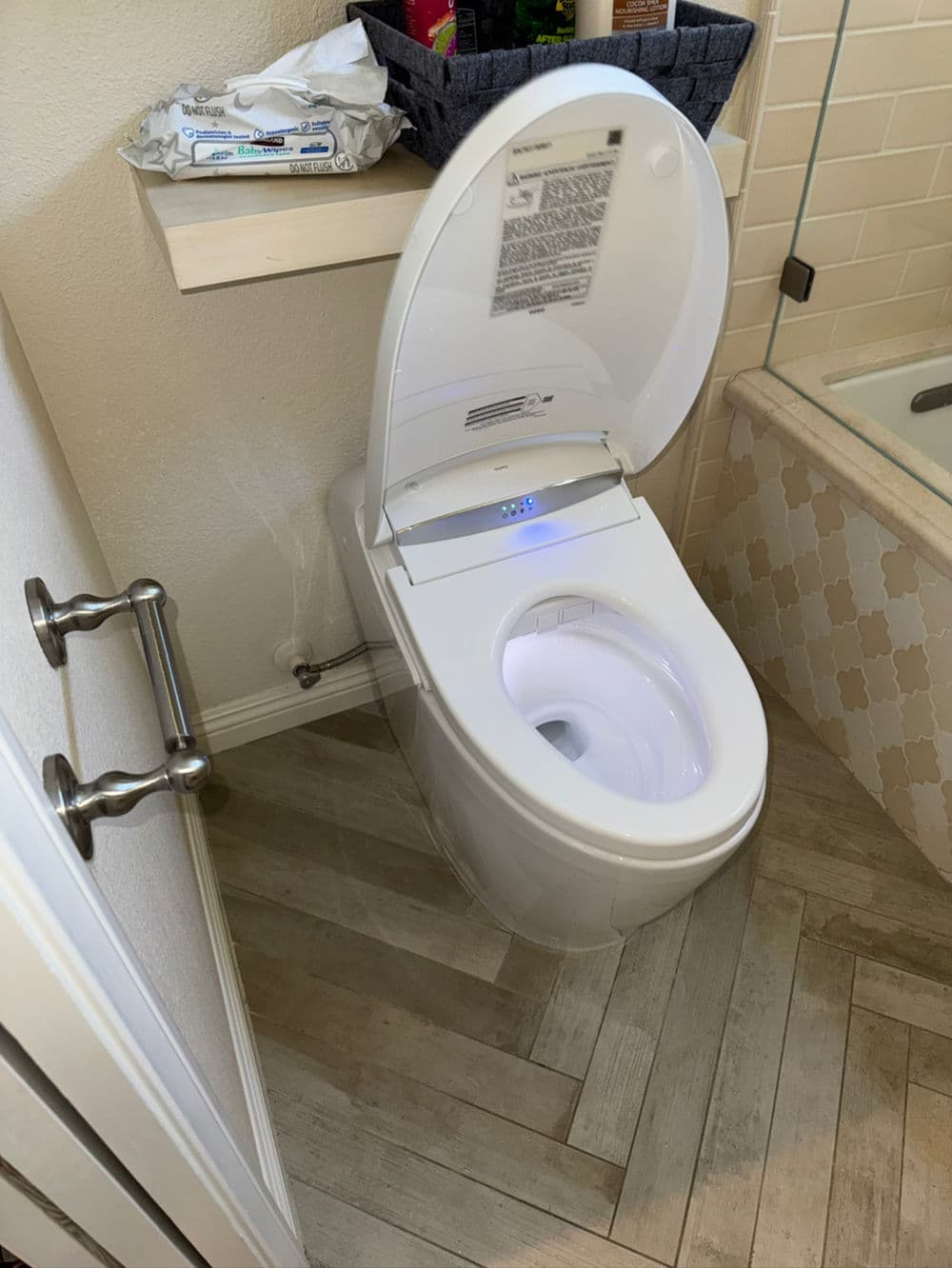 Modern bidet toilet with illuminated seat in stylish bathroom setting.