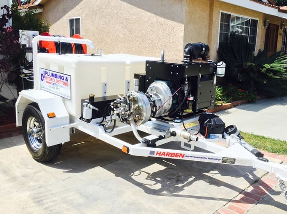 Mobile plumbing jetting trailer with high-pressure equipment for efficient drain cleaning.
